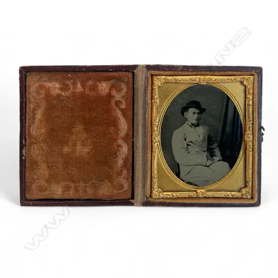 Gilt matted ambrotype - young man wearing a hat,